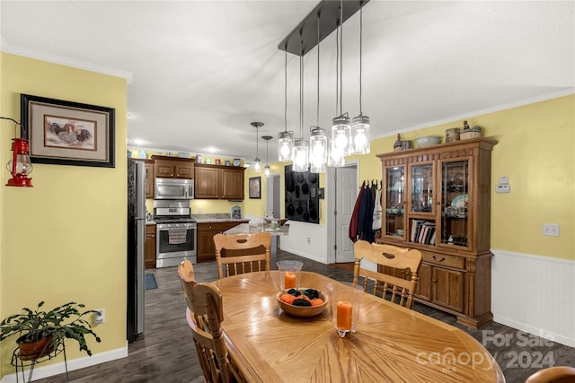 dining area with crown molding and dark hardwood / wood-style floors