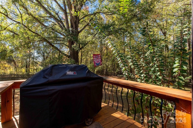 wooden deck with a grill