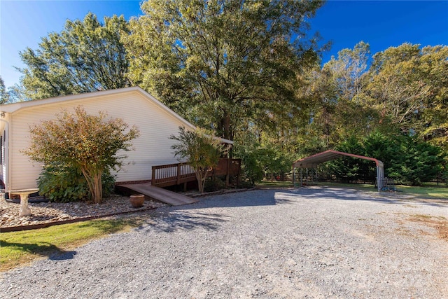 view of yard with a wooden deck and a carport