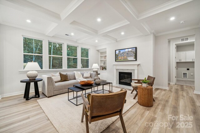 living room with built in features, light hardwood / wood-style floors, beamed ceiling, and a premium fireplace