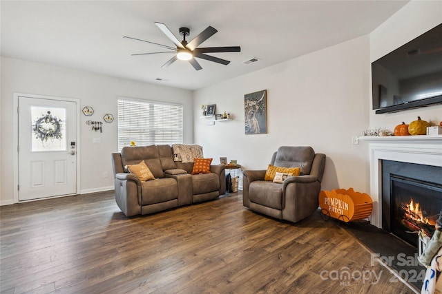 living room with ceiling fan and dark hardwood / wood-style floors