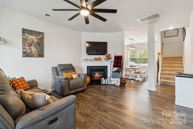 living room with dark wood-type flooring and ceiling fan