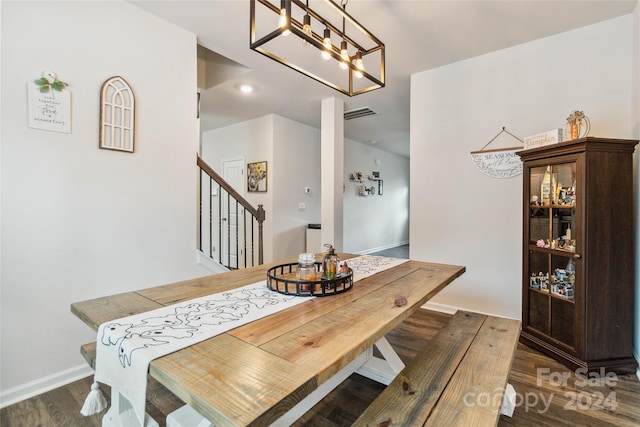 dining space featuring a notable chandelier and dark hardwood / wood-style flooring