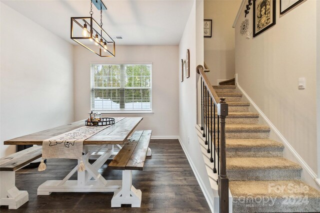 dining space with dark hardwood / wood-style flooring