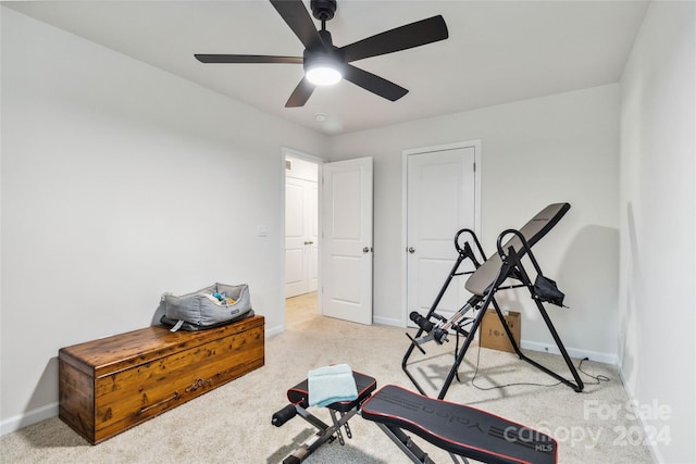 exercise area with light carpet and ceiling fan