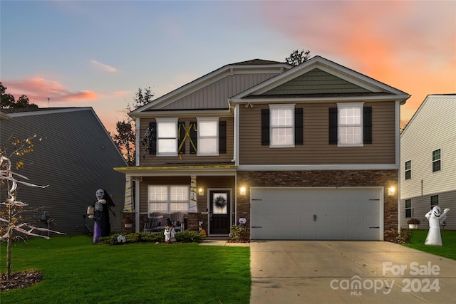 view of front of house featuring a yard and a garage