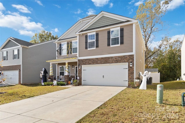 view of front of property featuring a front lawn and a garage