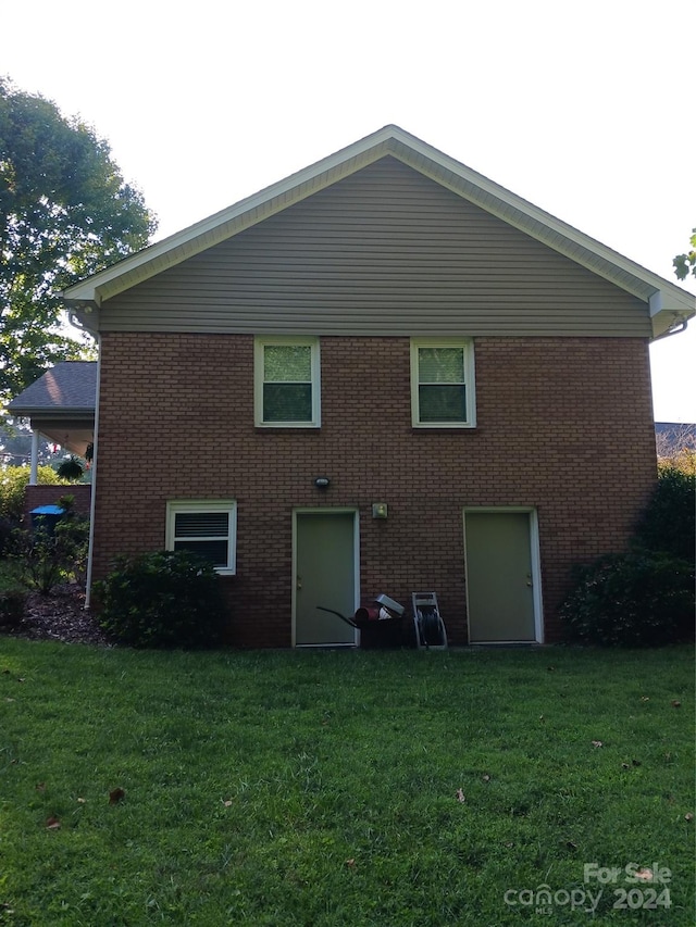 rear view of property with a yard