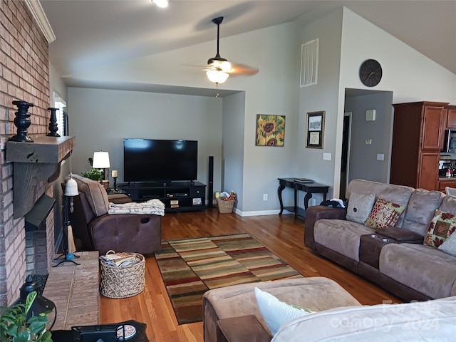 309 Rodoret St N, Valdese, NC 28690 - living area with a fireplace, a ceiling fan, visible vents, vaulted ceiling, and wood finished floors