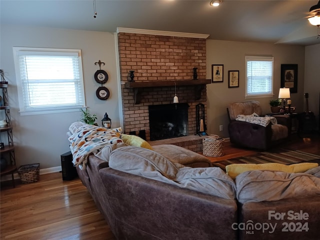 309 Rodoret St N, Valdese, NC 28690 - living area with ceiling fan, baseboards, wood finished floors, and a fireplace