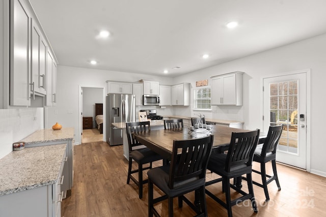 dining area featuring a wealth of natural light and dark hardwood / wood-style floors