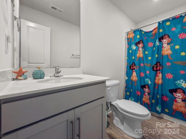 bathroom with hardwood / wood-style flooring, vanity, toilet, and a shower with curtain