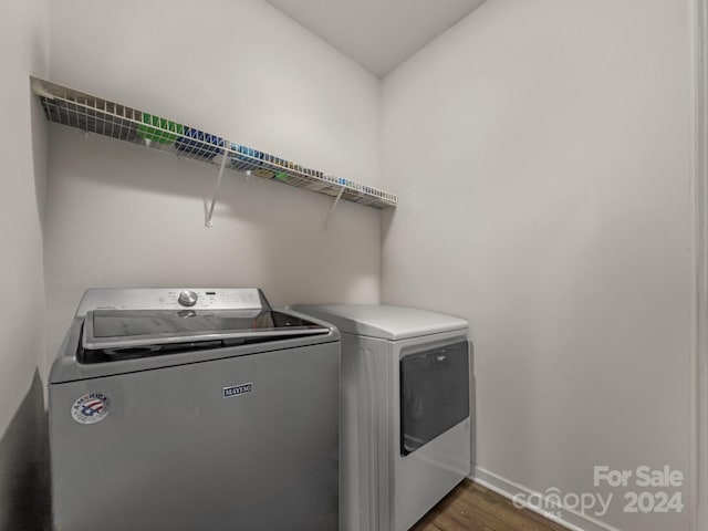 laundry area with washer and clothes dryer and dark hardwood / wood-style flooring