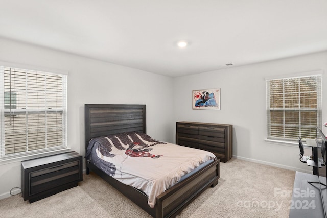 bedroom featuring light colored carpet