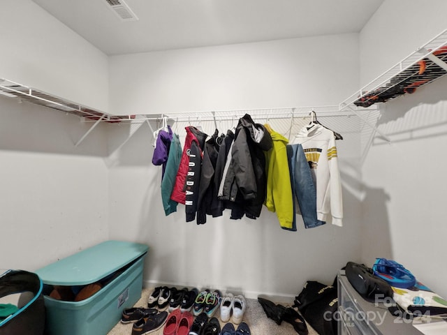 walk in closet with carpet