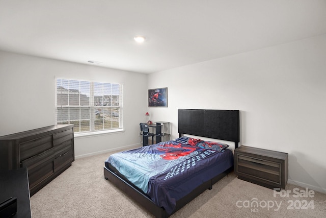 bedroom featuring light carpet