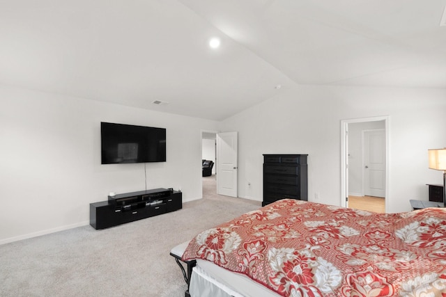 bedroom with lofted ceiling and light carpet