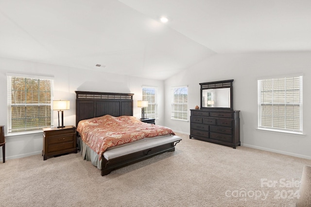 carpeted bedroom featuring lofted ceiling