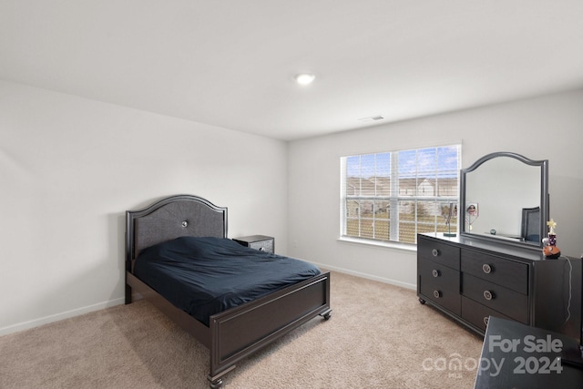 bedroom featuring light carpet