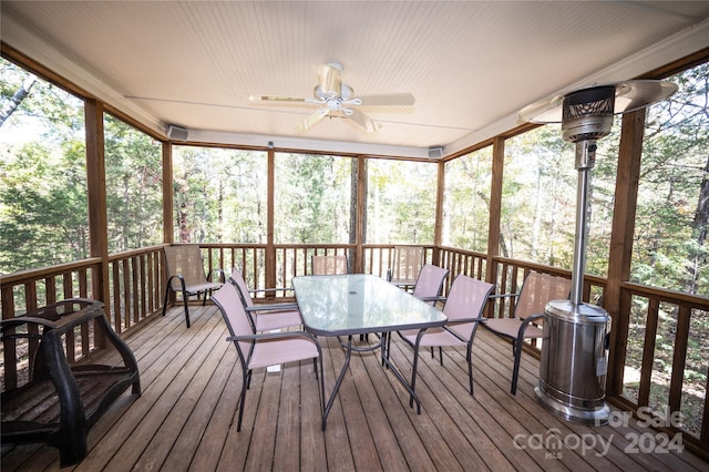 sunroom / solarium featuring ceiling fan