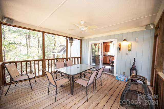 sunroom / solarium featuring ceiling fan