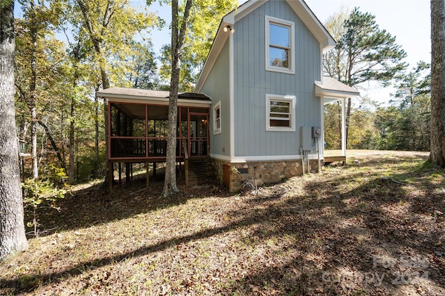 view of side of property with a sunroom