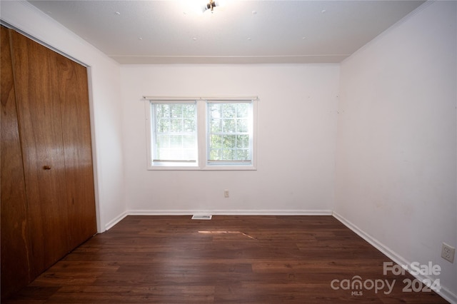 spare room with dark hardwood / wood-style flooring