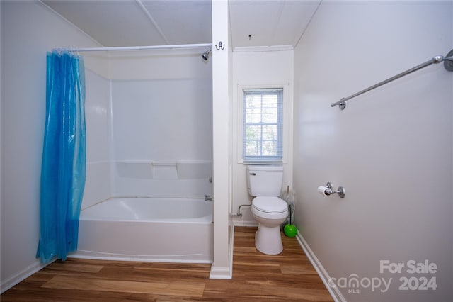 bathroom featuring shower / bath combination with curtain, toilet, hardwood / wood-style flooring, and crown molding