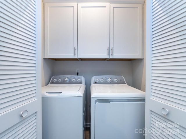 laundry room featuring cabinets and washing machine and clothes dryer