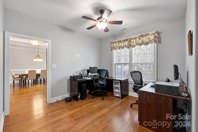 office area featuring light hardwood / wood-style flooring and ceiling fan with notable chandelier