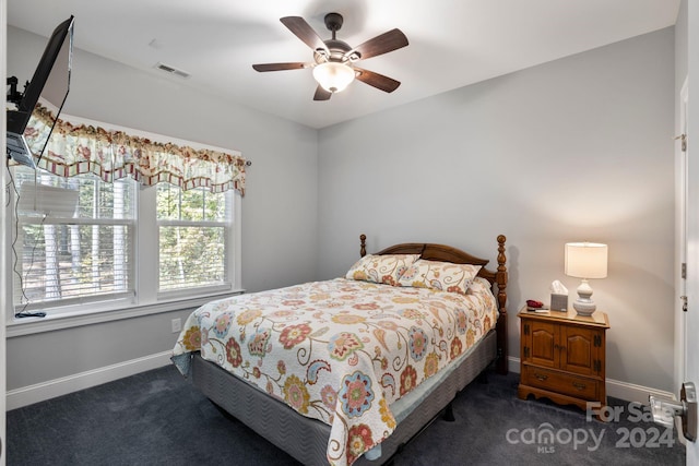 bedroom featuring dark colored carpet and ceiling fan