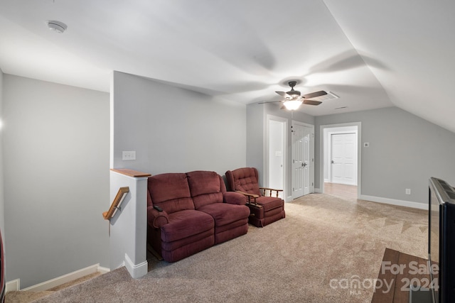 carpeted living room featuring ceiling fan and vaulted ceiling