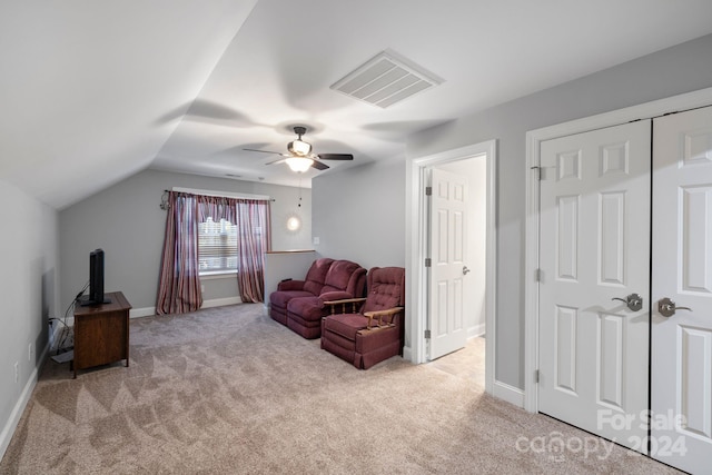 living area with light carpet, lofted ceiling, and ceiling fan