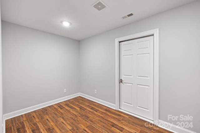 empty room with dark wood-type flooring