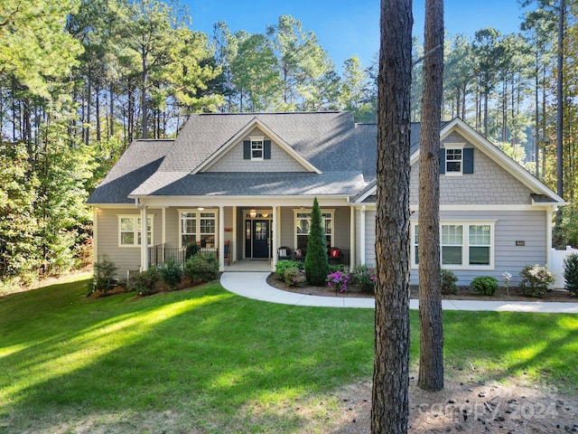 craftsman inspired home with covered porch and a front lawn