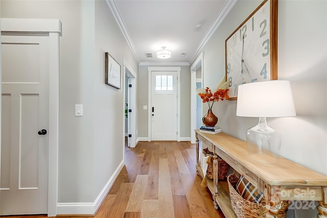 doorway to outside with crown molding and light hardwood / wood-style flooring