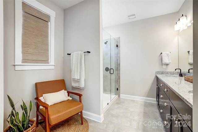 bathroom with vanity and a shower with door