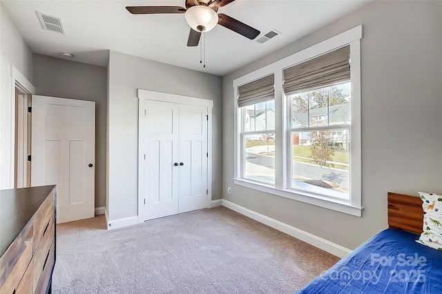 unfurnished bedroom featuring light carpet, visible vents, and baseboards