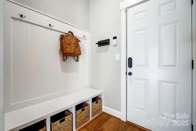 mudroom featuring baseboards and dark wood-style flooring