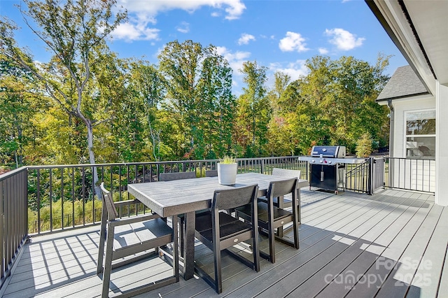 deck featuring grilling area and outdoor dining area