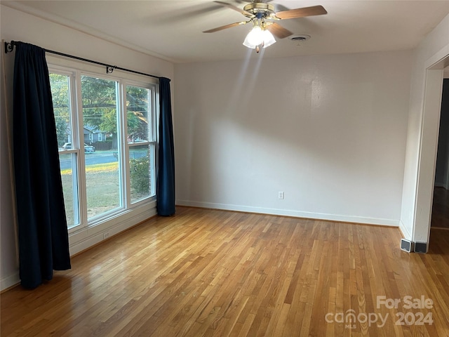 spare room featuring ceiling fan and light hardwood / wood-style flooring