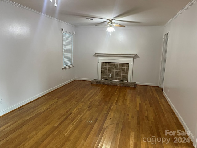 unfurnished living room featuring ceiling fan, crown molding, a fireplace, and hardwood / wood-style floors