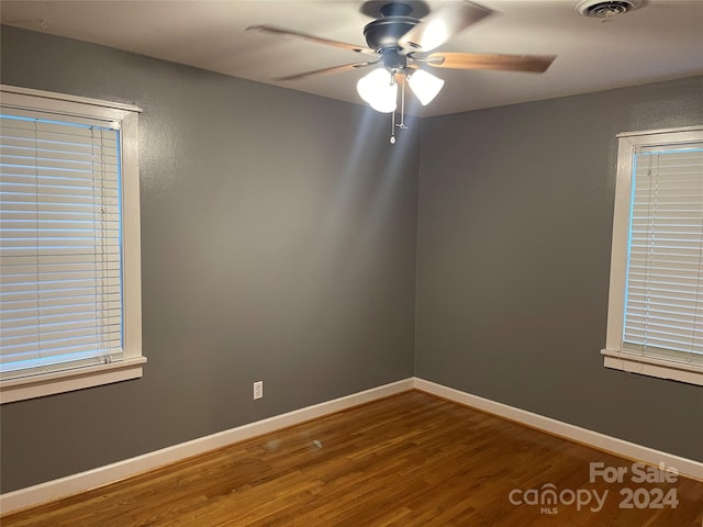 unfurnished room with hardwood / wood-style flooring and ceiling fan