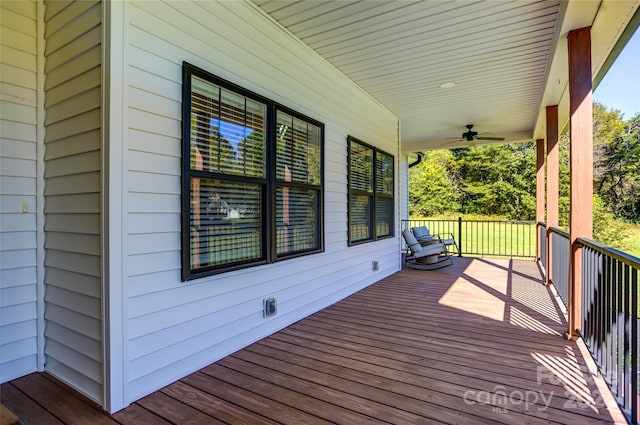 wooden terrace with covered porch and ceiling fan