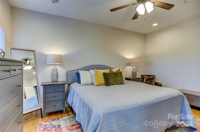 bedroom featuring hardwood / wood-style floors and ceiling fan