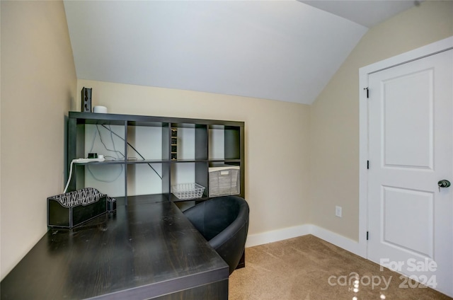 carpeted home office featuring lofted ceiling