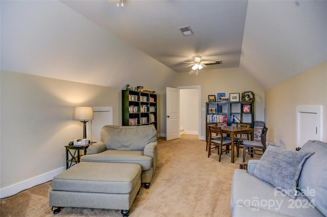 living room featuring lofted ceiling, light colored carpet, and ceiling fan