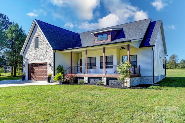 view of front of house with a front lawn, covered porch, a garage, and ceiling fan