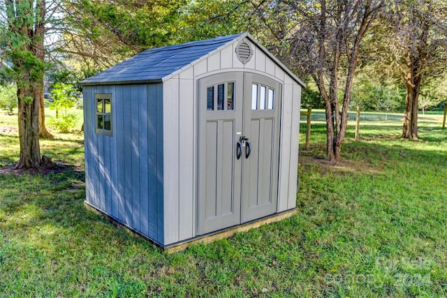 view of outbuilding featuring a lawn