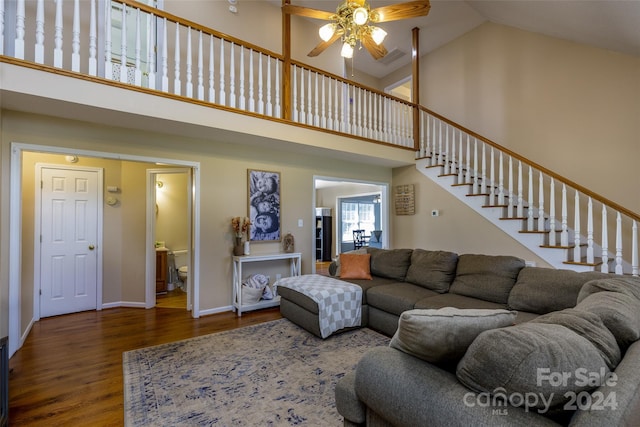 living room with hardwood / wood-style floors, high vaulted ceiling, and ceiling fan